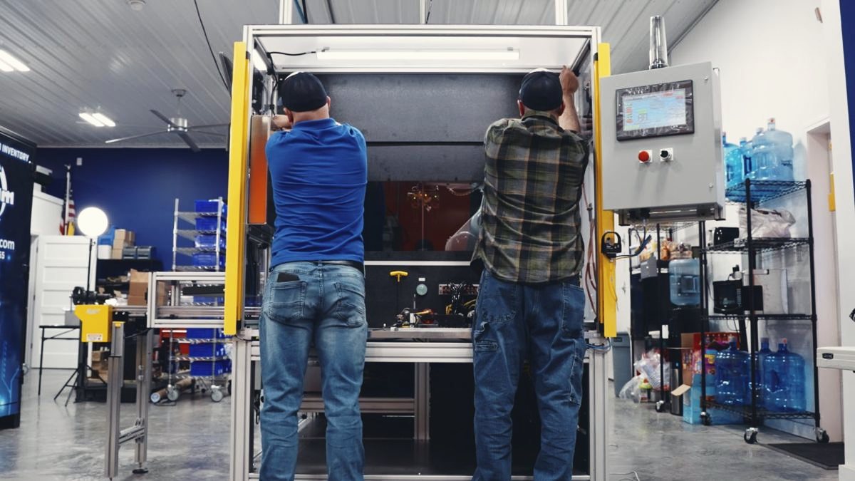 Team assembling a leak test machine
