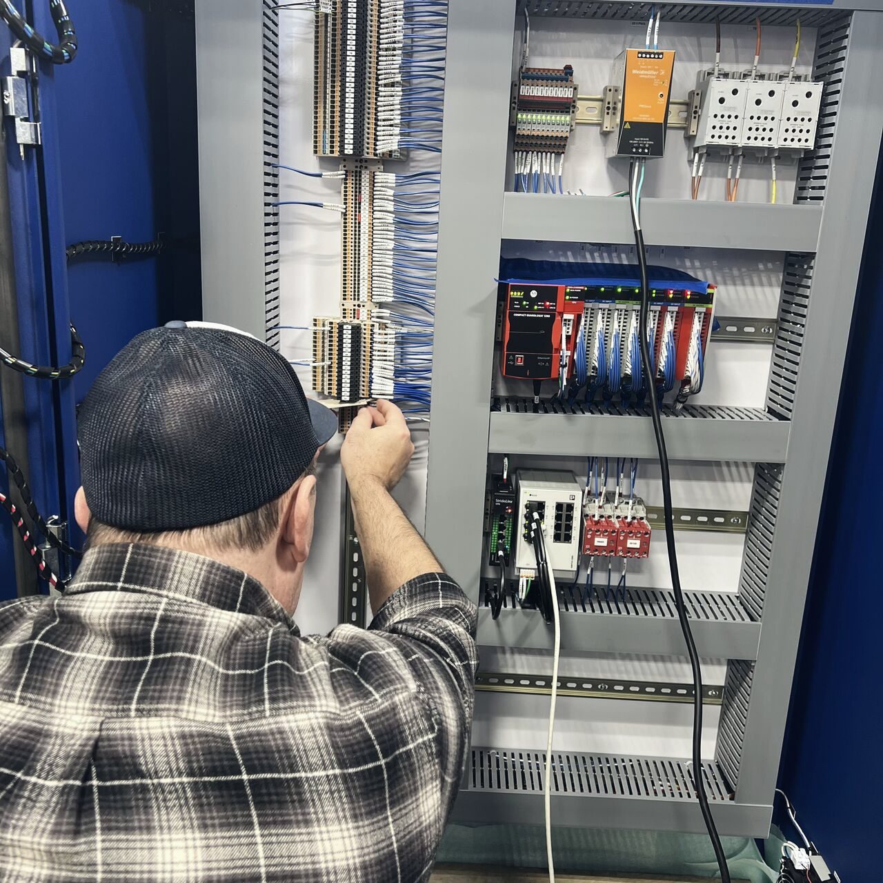 Envision technician wiring a control panel